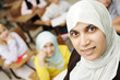 Muslim female teacher in classroom with children pupils Muslim female teacher in classroom with children pupils