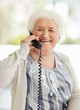 Happy mature woman talking over telephone
