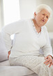 Senior woman suffering from back pain at home