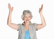 Happy mature woman with her hands raise isolated against white