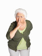 Senior woman making gesture for quiet isolated against white