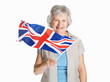 Happy female holding a flag of United Kingdom against white