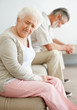 Depressed mature couple sitting on sofa after a quarrel