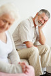 Depressed mature man looking at a sad senior woman