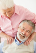 Relaxed mature man receiving shoulder massage from a woman