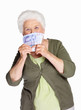 Mature woman smelling paper currency isolated against white