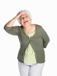 Happy senior woman shielding her eyes isolated against white