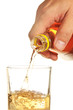 man's hand pours a drink into a glass
