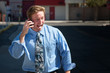 Good-looking guy excitedly talks on cell phone