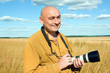 Bald man with camera Bald man with camera