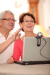 Closeup of senior couple waiving at webcam