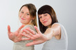Foto: two young woman with hands up two young woman with hands up