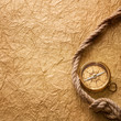 old compass and rope on vintage paper