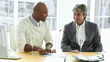 two happy businessmen concluding a contract with champagne