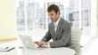 serious businessman working on his laptop in his office