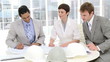 Video: joyful architects looking at plans in the office joyful architects looking at plans in the office