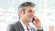 charismatic man on phone sitting in his office