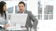 two colleagues working at a computer