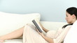 Video: pregnant woman reading lying in the living-room pregnant woman reading lying in the living-room