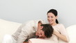 Vidéo : Loving couple expecting a baby sitting on sofa Loving couple expecting a baby sitting on sofa