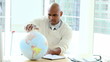 Video: Ethnic businessman looking at a terrestrial globe Ethnic businessman looking at a terrestrial globe