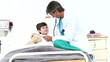 doctor playing with a little patient lying in a bed