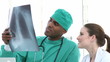 male and female doctors looking at x-ray