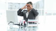 angry man working with his computer sitting in his office