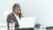 businessman on phone working with computer in his office
