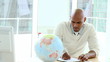 Video: african business man writing looking at a terrestrial globe african business man writing looking at a terrestrial globe