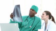 two attractive doctors looking at an x-ray