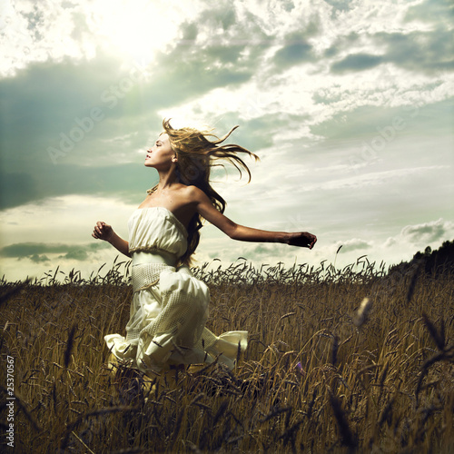Photo: Girl running across field Girl running across field