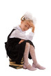 Schoolgirl sitting on a pile of books