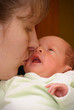 Mother kissing baby