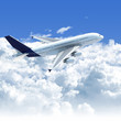 Photo: airplane flying over the clouds side top view airplane flying over the clouds side top view