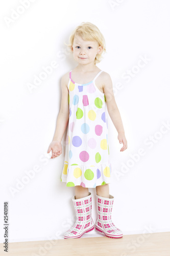 little girl wearing dress and rubber boots