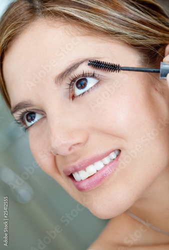 Woman putting make up Woman putting make up