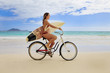 teenage girl with surfboard and bicycle on kailua beach teenage girl with surfboard and bicycle on kailua beach