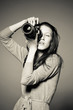 Monochrome portrait of beautiful female photographer shooting