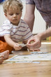 germany, berlin, father helping son (3-4) to put puzzle together