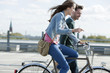 germany, berlin, young couple with bicycle