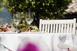 Photo: italy, south tyrol, laid table, with mixed salad on plates and two glasses with white wine italy, south tyrol, laid table, with mixed salad on plates and two glasses with white wine