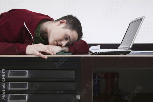Photo: tired man lying on desk tired man lying on desk