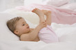 baby girl (6-11 months) sticking out tongue with feet up