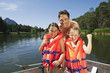 Photo: italy, south tyrol, father and children (6-7) (8-9), wearing life jackets, smiling, portrait italy, south tyrol, father and children (6-7) (8-9), wearing life jackets, smiling, portrait