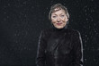 woman standing in rain, smiling.