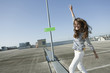 germany, berlin,young woman on deserted parking level dancing, smiling, portrait