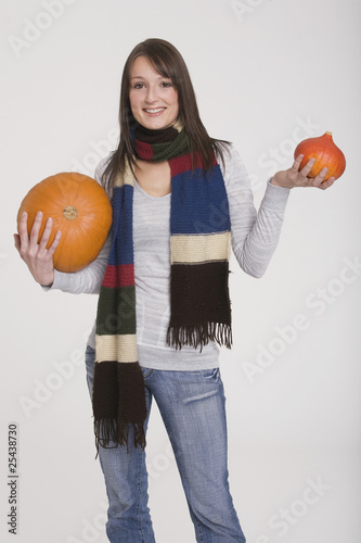 Photo: young girl holding two pumpkins young girl holding two pumpkins