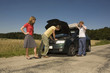 germany, bavaria, three friends with broken down car