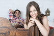 germany, bavaria, young woman, man in background lying in bed